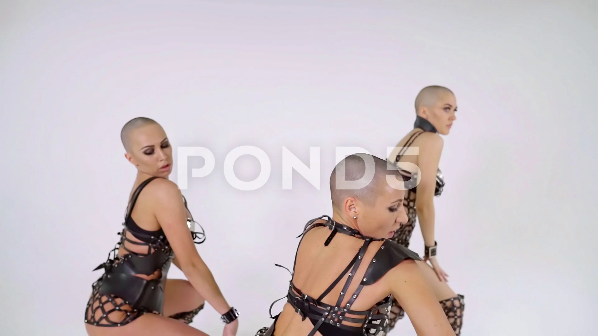 three sexy bald girls rehearsing dance on white isolated background in  leather