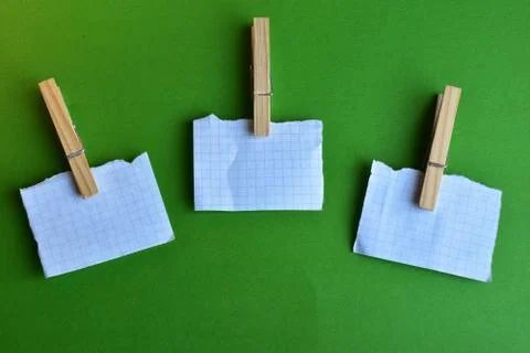 Three sheets for writing on three clothespins Stock Photos