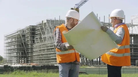 Three shipyard technicians comparing the changes to make to the project Stock Footage 72303777