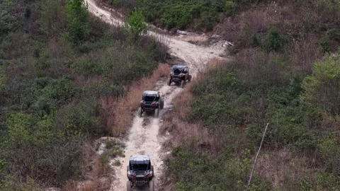 Three side-by-sides driving away from drone Stock Footage 344999404