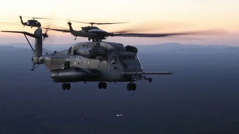 Three Sikorsky CH-53E Super Stallion helicopters flying during sunset Stock Footage 83467089