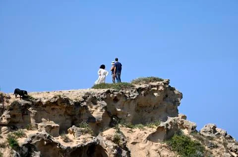 Three silhouettes on a rock Stock Photos