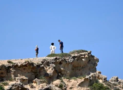 Three silhouettes on a rock Stock Photos