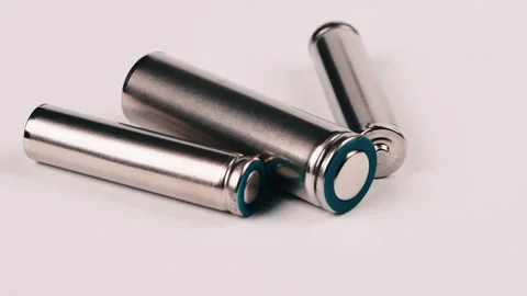 Three silver AA and AAA batteries isolated on white. Side view Stock Footage 237694011