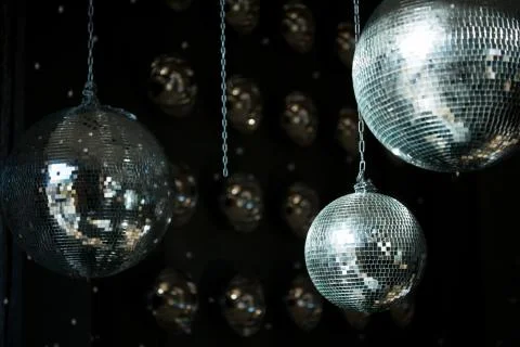 Three silver disco balls on a dark background. Parties and holidays concept. Stock Photos