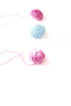Three skeins of multi-colored yarn on light background Stock Photos
