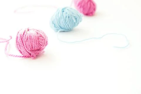 Three skeins of multi-colored yarn on light background Stock Photos