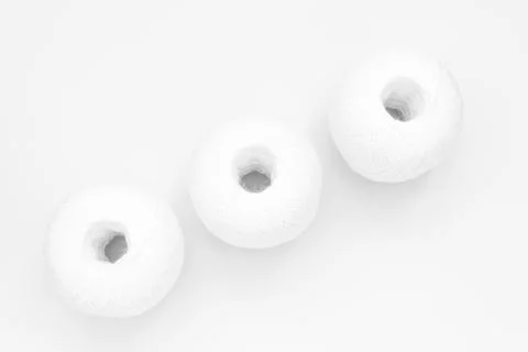 Three skeins of white thread on white background, abstract background Stock Photos