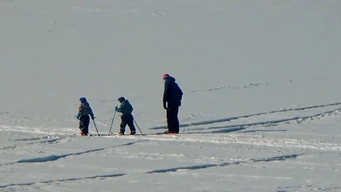 Three skiers move through the snow Stock Footage 88472982