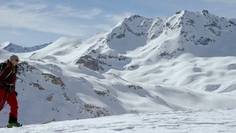 Three skilled skiers walking with ski pole on snowy surface Stock Footage 116787954