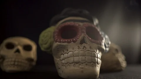 Three Skulls close up, one with smoke coming out of their eye holes Stock Footage 96635362