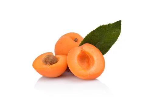 Three sliced apricots with leaf isolated on white background Stock Photos