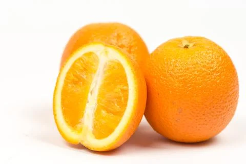 Three sliced oranges isolated over white background Stock Photos