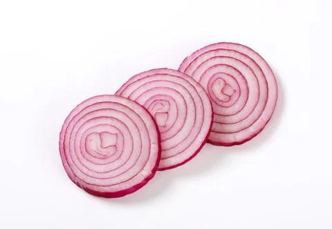 Three sliced red onions on plain background Stock Photos