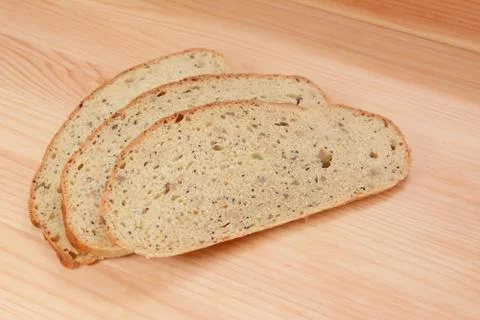 Three slices of bread on a wooden table Stock Photos