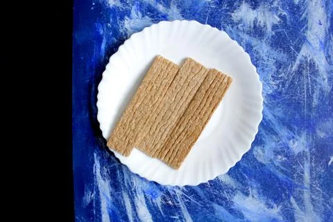 Three slices of crispy bread on a blue background Stock Photos