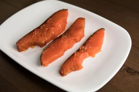 Three slices of fish on a plate Stock Photos
