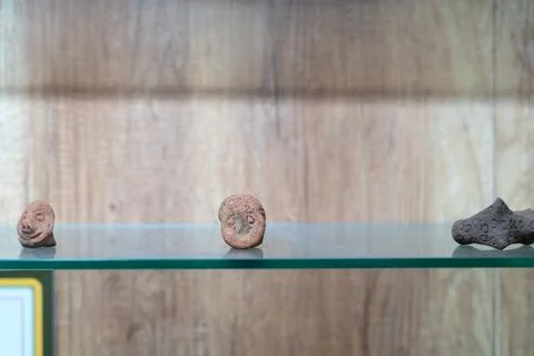Three small brown objects are on a shelf. in Chennai Stock Photos