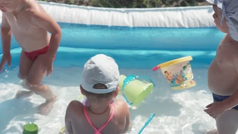 Three small children  are happy bathe and frolic in pool in summer Stock Footage 138077347
