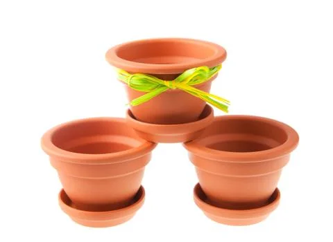 Three small clay flower pots with saucers Stock Photos