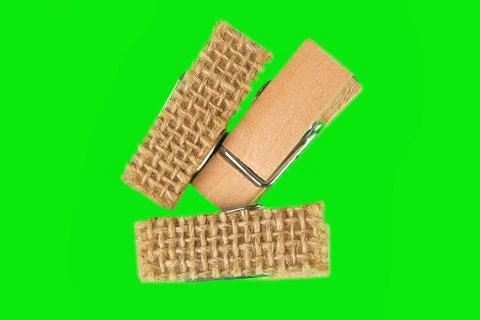 Three small clothespins in green background Foto stock