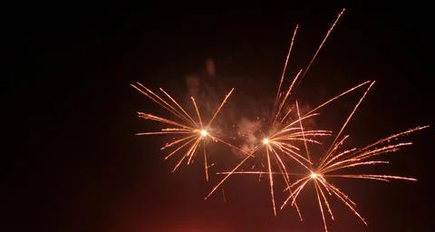 Three small firework explosions in night sky Stock Photos