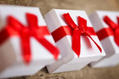 Three small gift boxes for presents on wooden table 库存照片