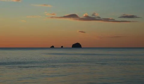 Three small islands at sunset. Stock Photos