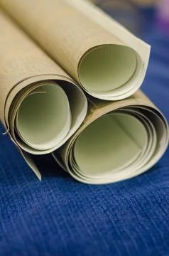 Three small rolls of wallpaper on blue background Foto stock