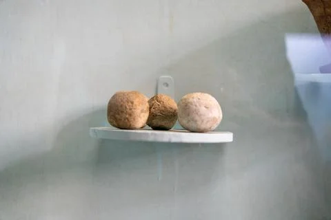 Three small round objects are on a shelf. in Chennai Stock Photos