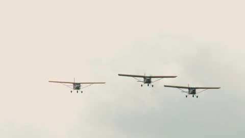 Three small single engine airplanes doing stunts Stock Footage 69932574