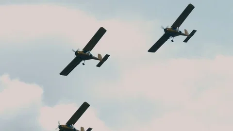 Three small single engine airplanes doing stunts Stock Footage 69932995