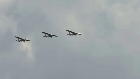 Three small single engine airplanes doing stunts Stock Footage 69933027