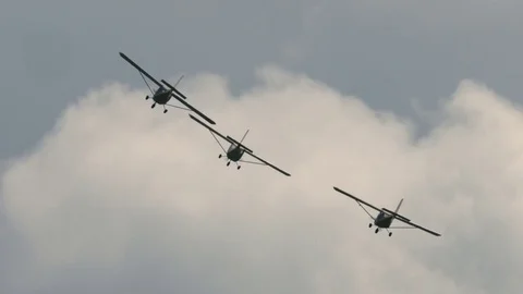 Three small single engine airplanes doing stunts Stock Footage 69933473