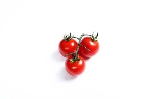 Three small tomatoes on white 스톡 사진