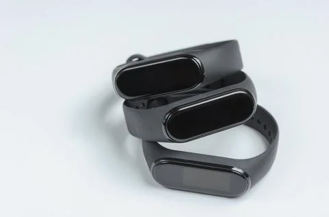 Three smart bracelets on a white background. Modern gadgets for sports and ev Stock Photos