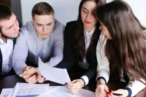 Three smart men and two cute girl programmers make up Concept of Stock Photos