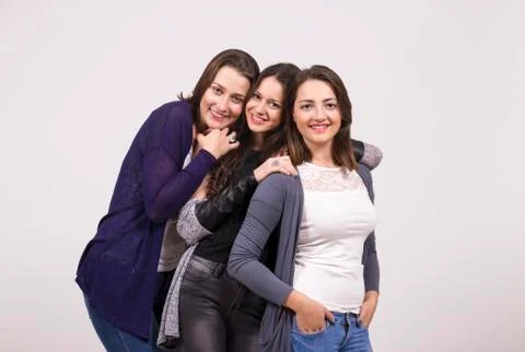 Three smiling girls, portrait. studio shot, white background Stock Photos