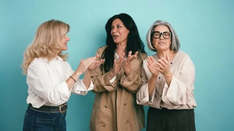 Three smiling mature women clapping hands in celebration Stock Footage 340170671