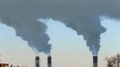 Three smoke or steam stacks on blue sky background. Stock Footage 38597085
