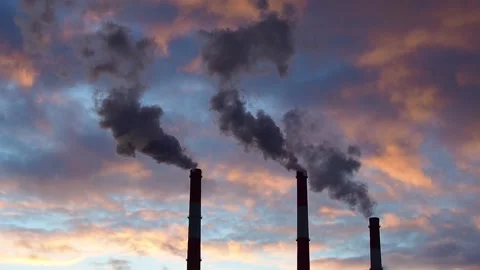 Three Smoking chimneys in dramatic colorful sky background Stock Footage 144945754