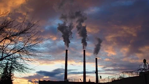 Three Smoking chimneys in dramatic colorful sky background Stock Footage 144945756