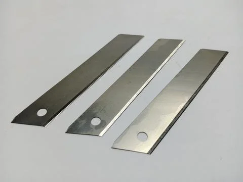Three Snap-Off Utility Knife Replacement Blades on White Surface Stock Photos