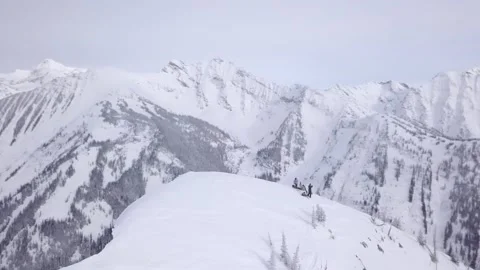 Three snowboarders at the summit of a mountain Stock Footage 150239672