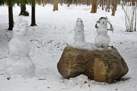 Three snowman in spring. Stock Photos