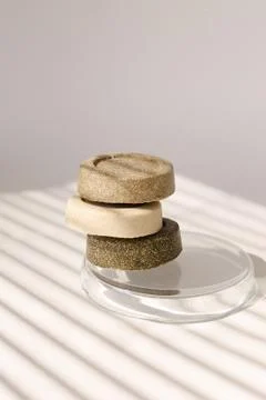 Three soap solid bars on striped shadow background. Stock Photos