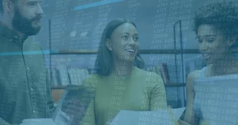 Three software developers reviewing code printout and laptop screen in office, 库存照片