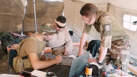 Three soldiers in a tent discuss a plan to attack the enemy Stock Footage 248447476