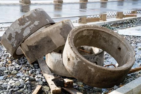 Three solid concrete rings are carefully stacked on top of one another, pos.. Stock Photos