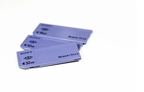 Three Sony Memory Stick cards of different capacities stacked on a white back Stock Photos